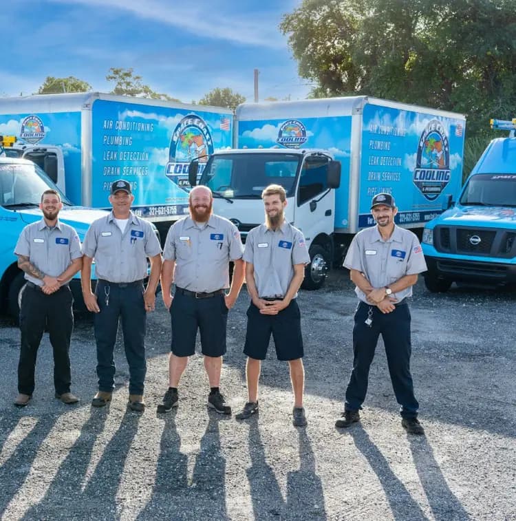 Space Coast Cooling & Plumbing team standing in front of service vehicles
